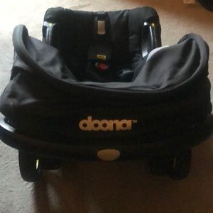 Doona car seat with retractable wheels and base for infant